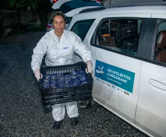 Lucia standing next to her car before going to release mosquitoes